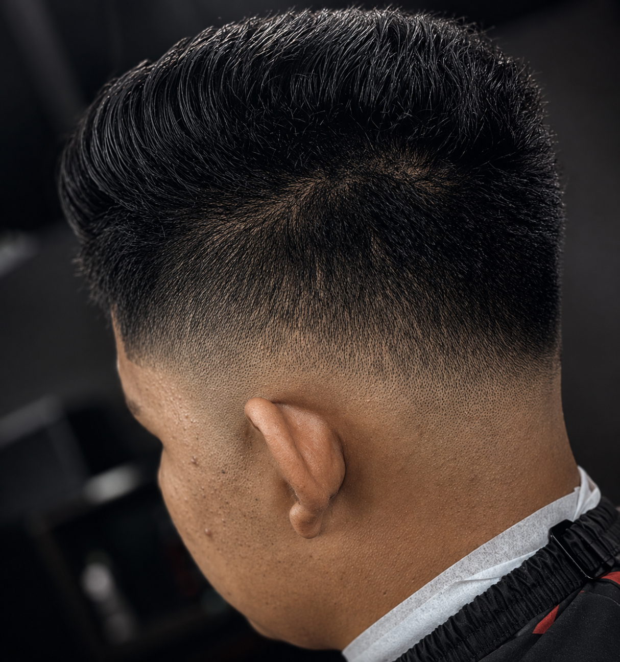 Low taper fade with textured comb-over, back view