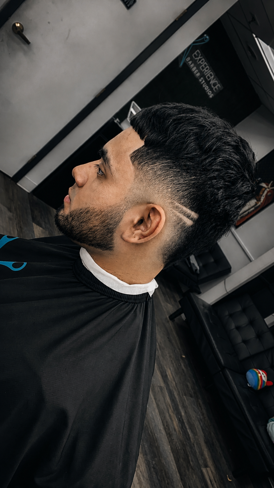 Mid fade with sharp lineup and shaved part detail